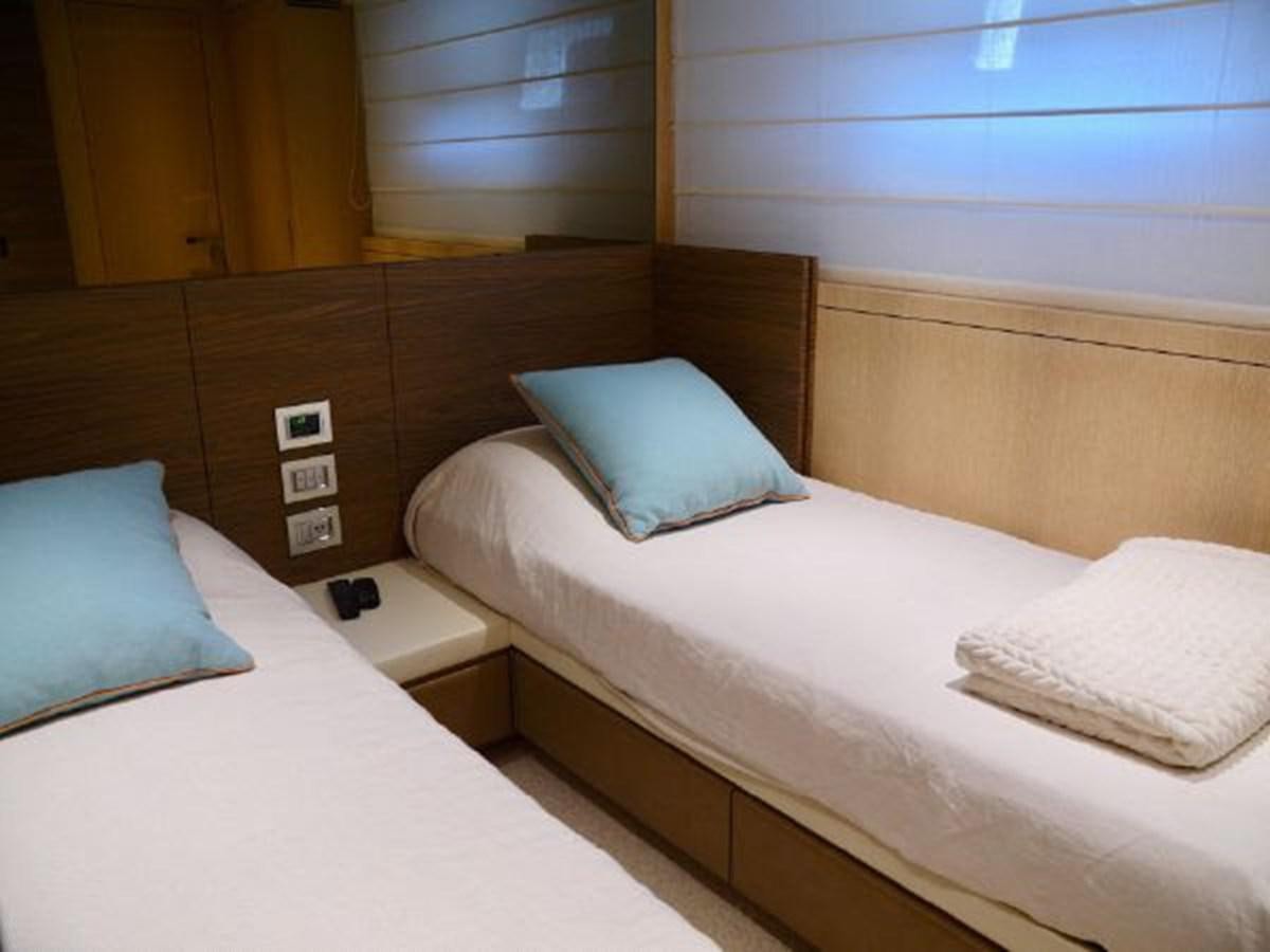 a room with a bed and a window aboard ASTONISH Yacht for Sale