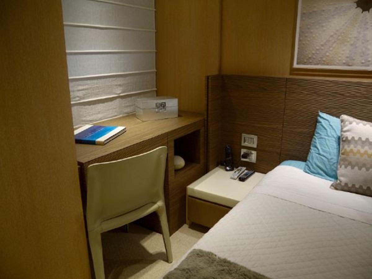 a bed and desk in a room aboard ASTONISH Yacht for Sale