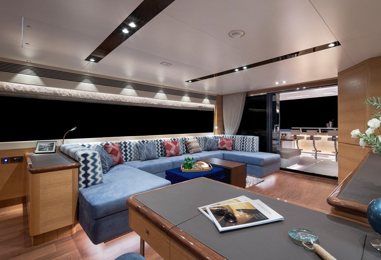 a living room with a blue couch aboard FD92 (NEW BOAT SPEC)  Yacht for Sale