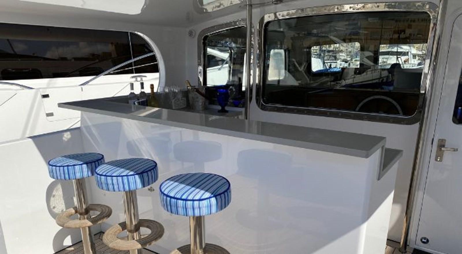a room with a table and chairs aboard TELSTAR VI Yacht for Sale