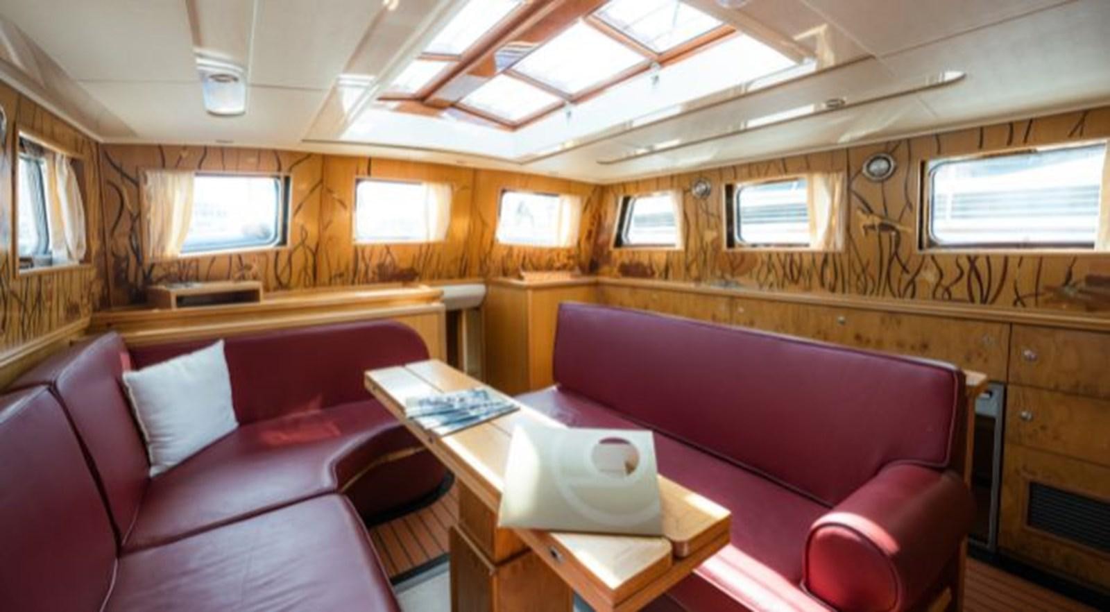 a train car with a desk and a chair aboard TELSTAR VI Yacht for Sale