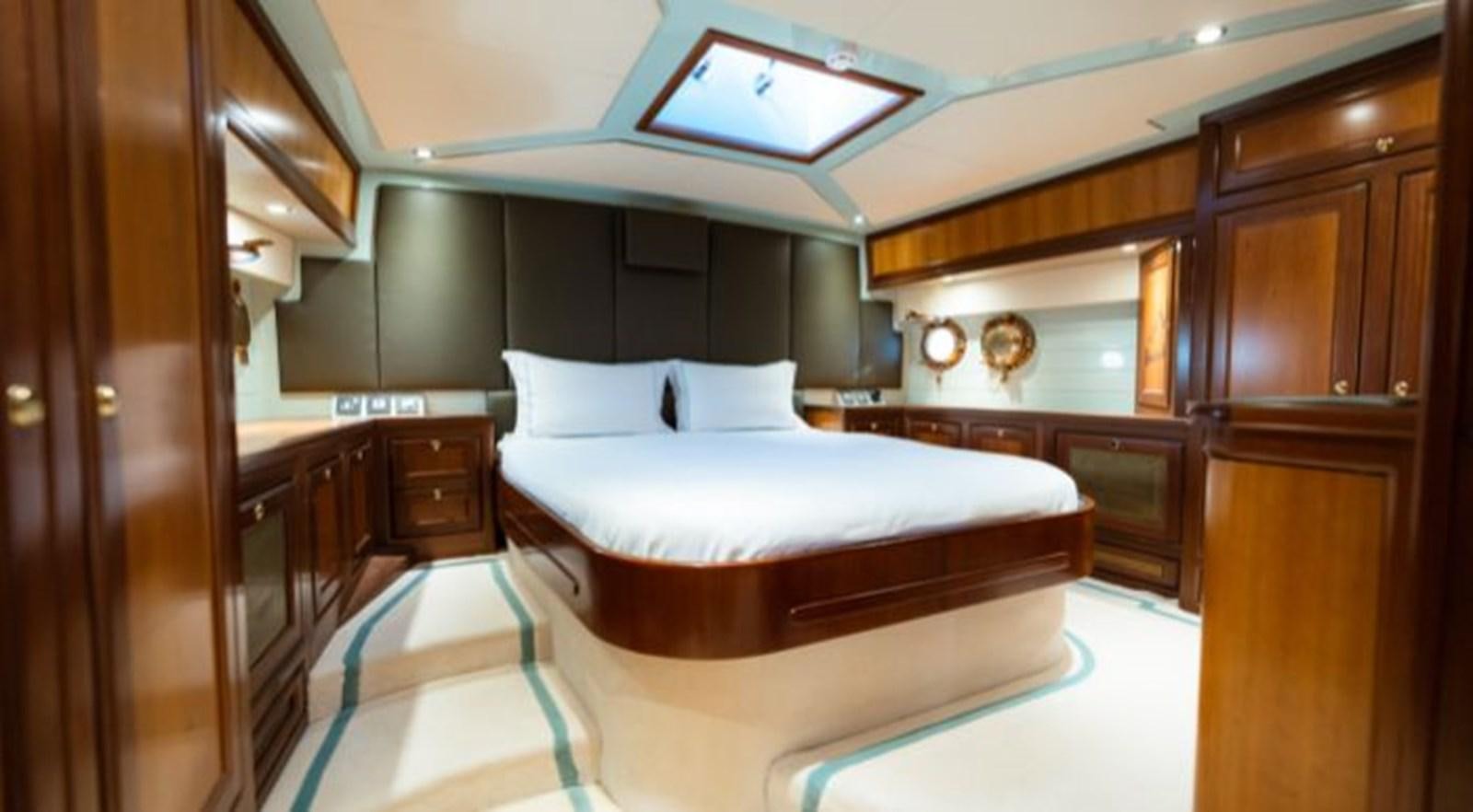 a bedroom with a bed and cabinets aboard TELSTAR VI Yacht for Sale