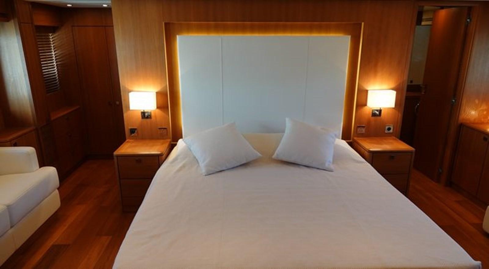 a bed with white sheets aboard NOE Yacht for Sale