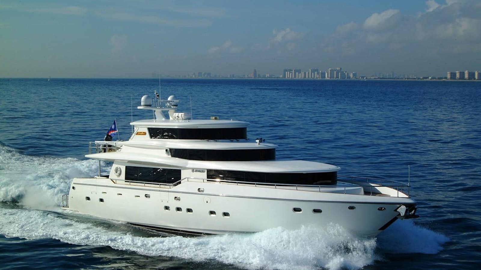 a white boat on the water aboard JOHNSON 93 SKYLOUNGE Yacht for Sale