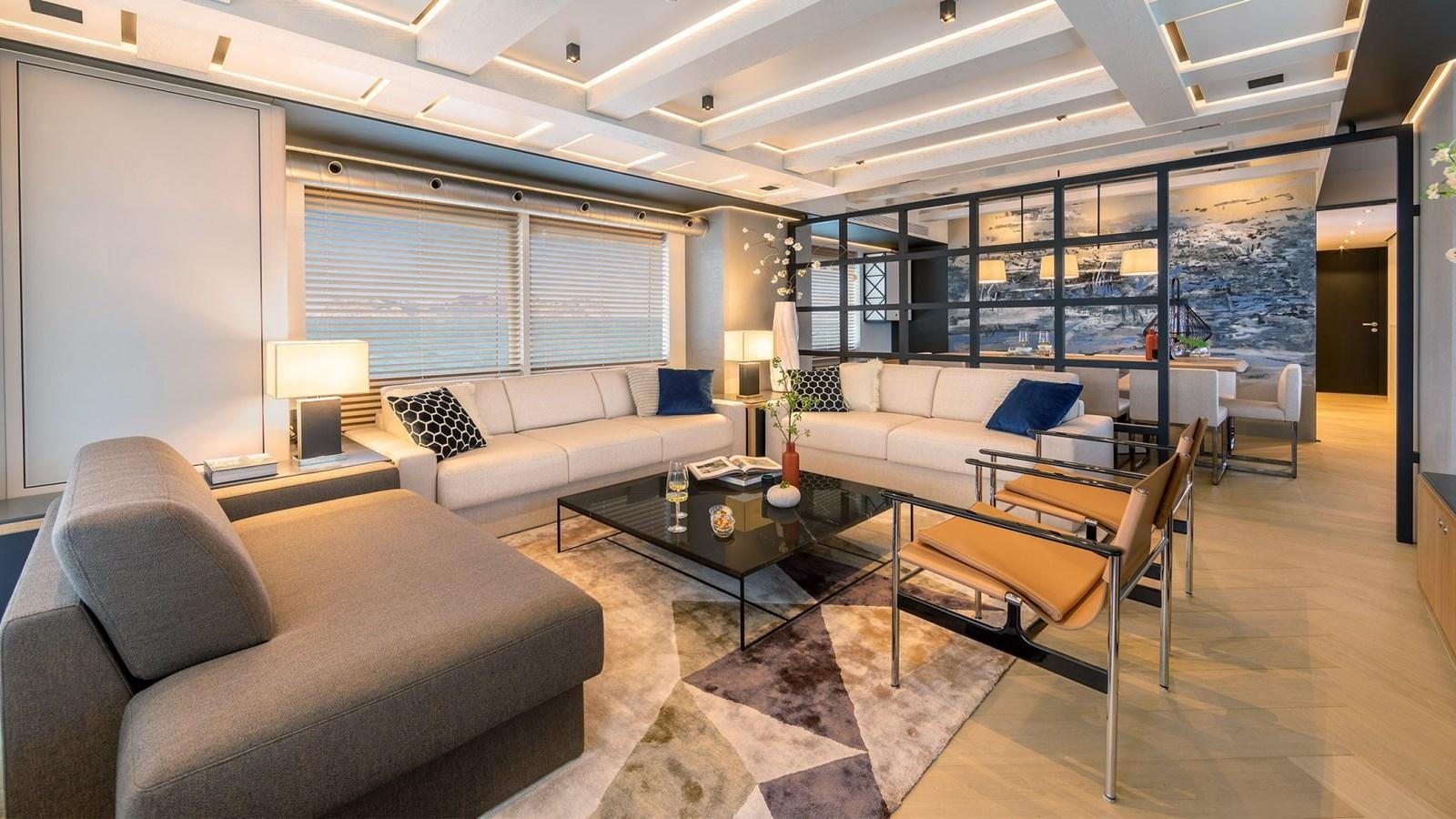 a living room with a couch and a coffee table aboard BLONDIE Yacht for Sale