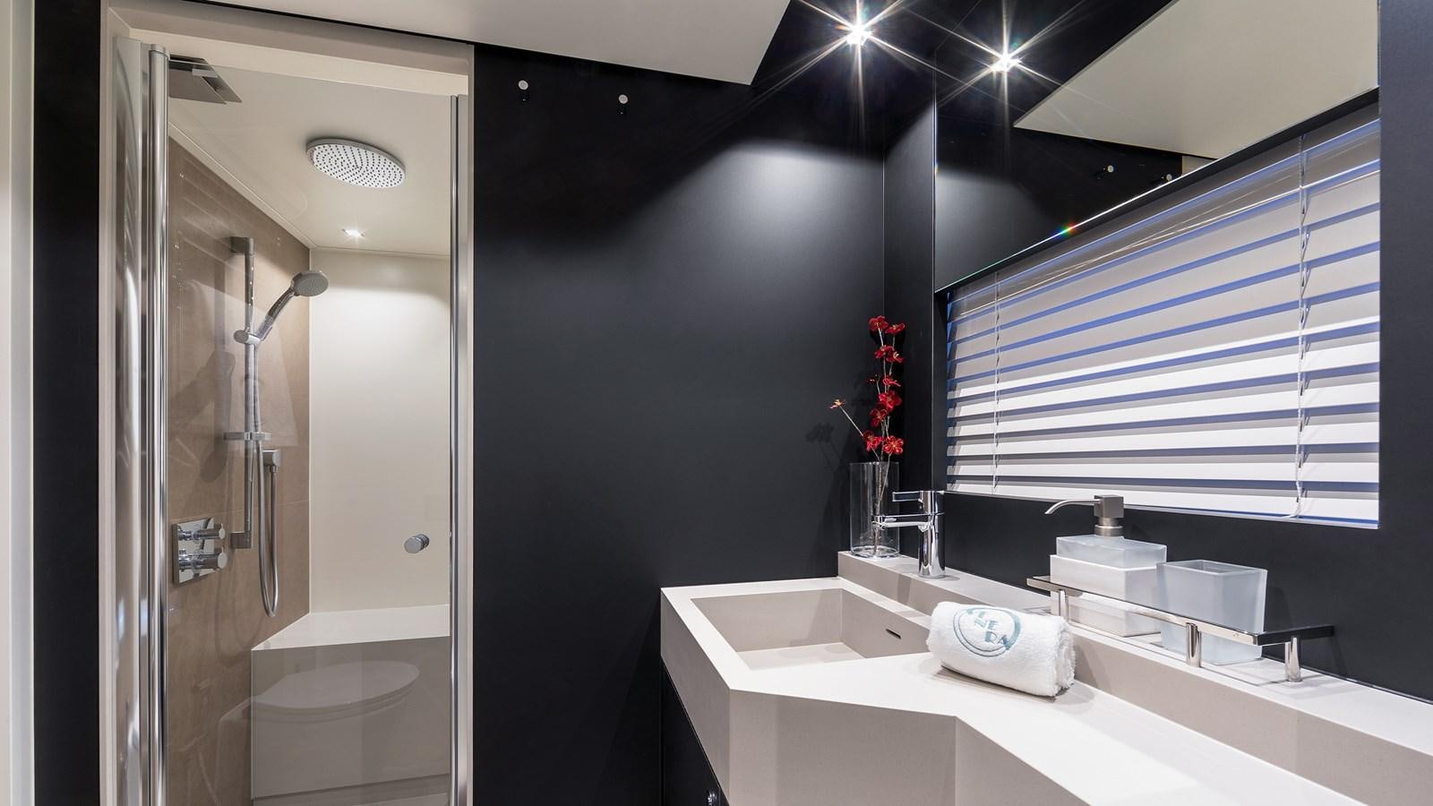 a bathroom with a sink and a shower aboard BLONDIE Yacht for Sale