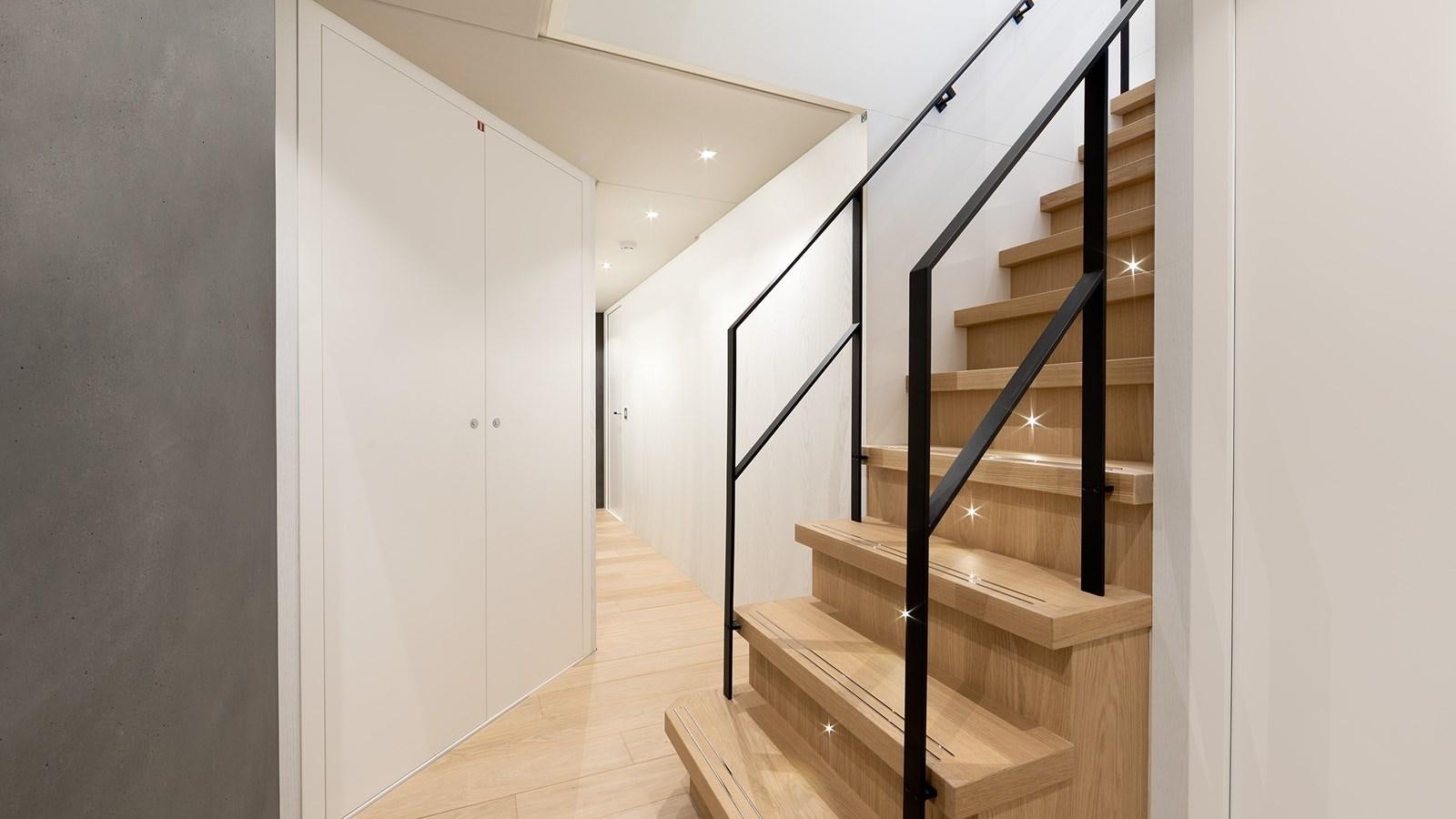 a staircase with white walls aboard BLONDIE Yacht for Sale