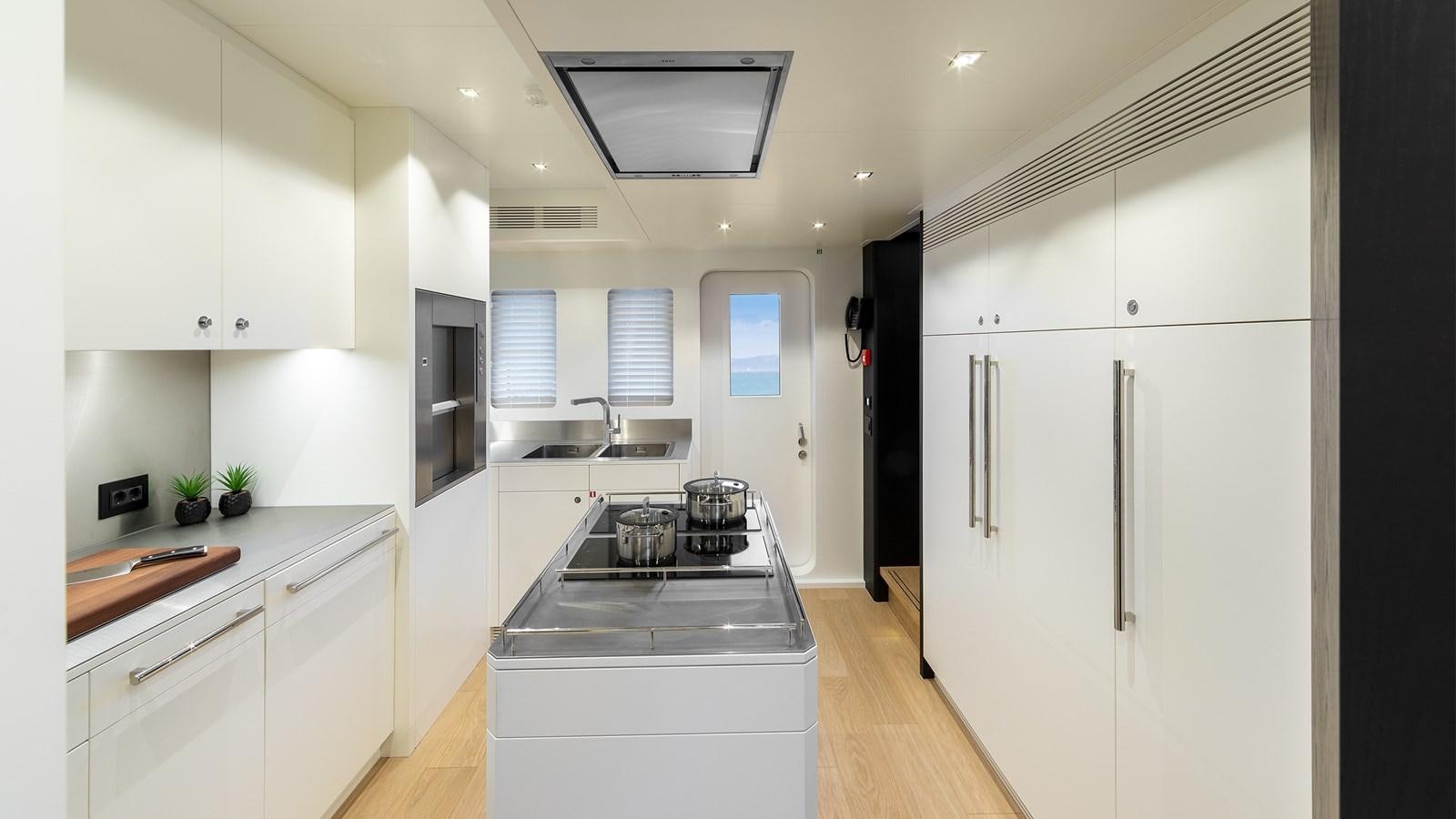 a kitchen with white cabinets aboard BLONDIE Yacht for Sale