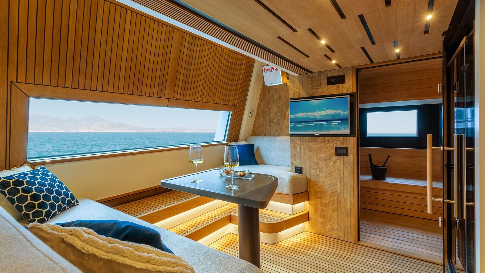 a room with a table and a bed aboard BLONDIE Yacht for Sale