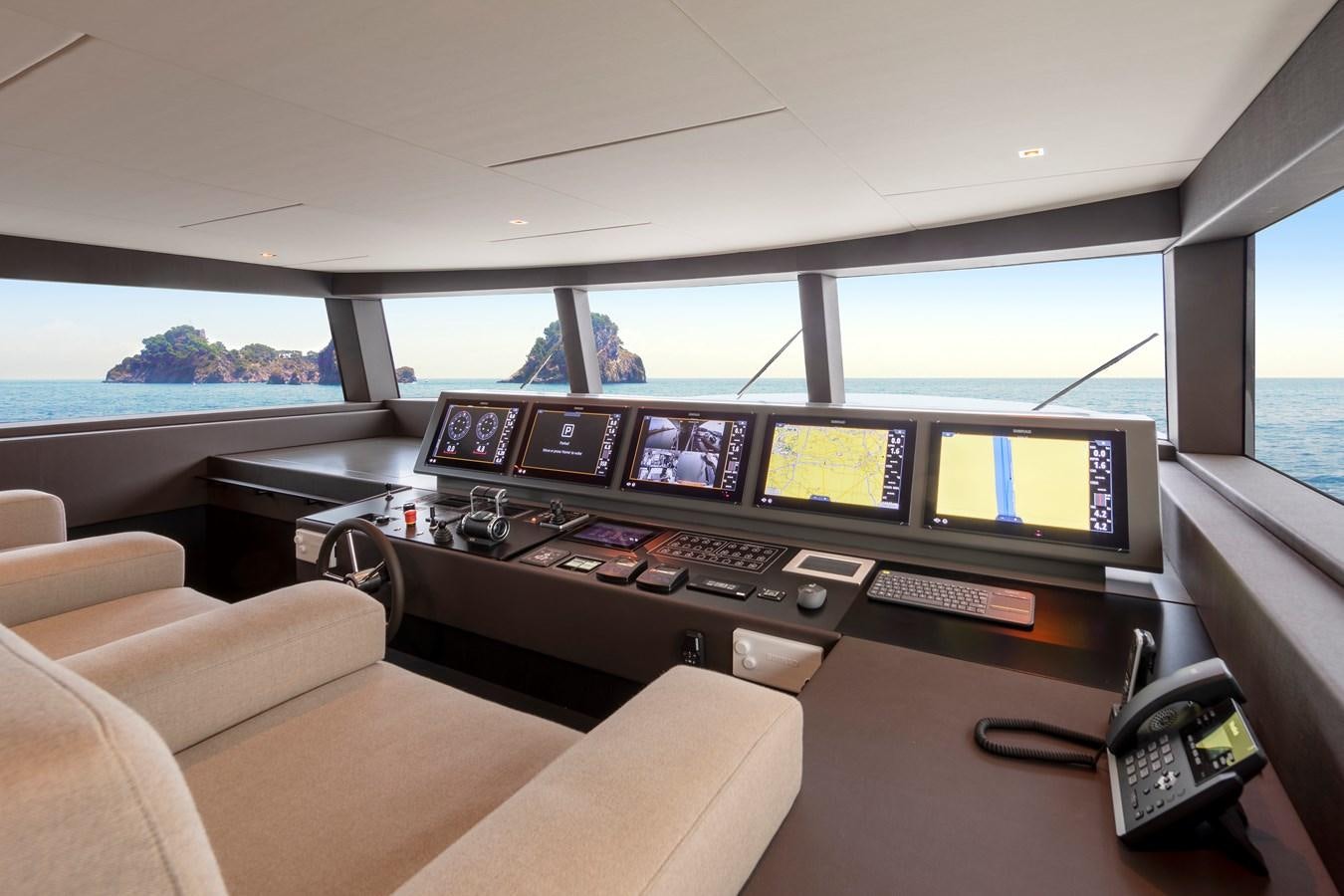 a room with many monitors and a couch aboard BLONDIE Yacht for Sale