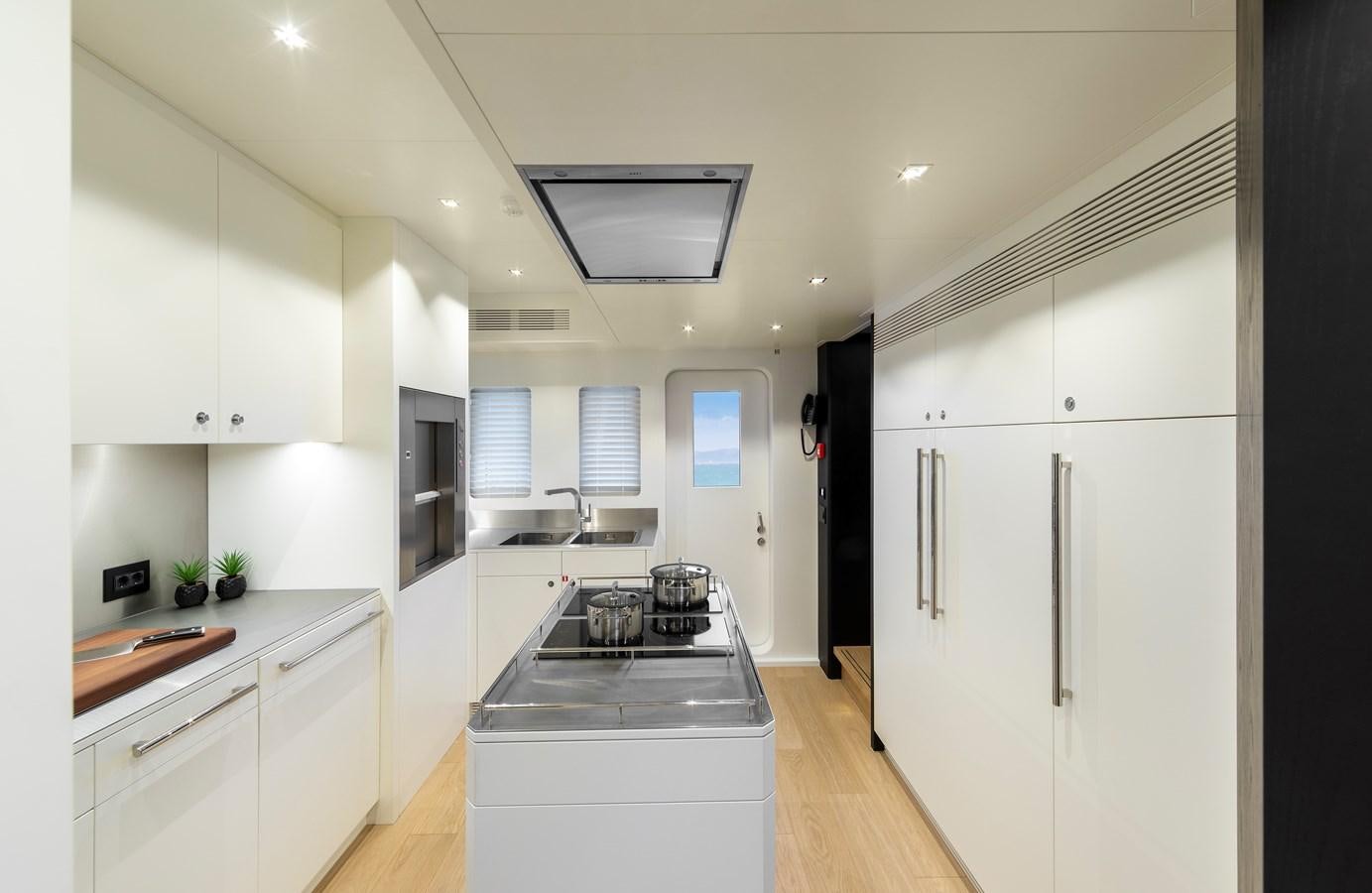 a kitchen with white cabinets aboard BLONDIE Yacht for Sale
