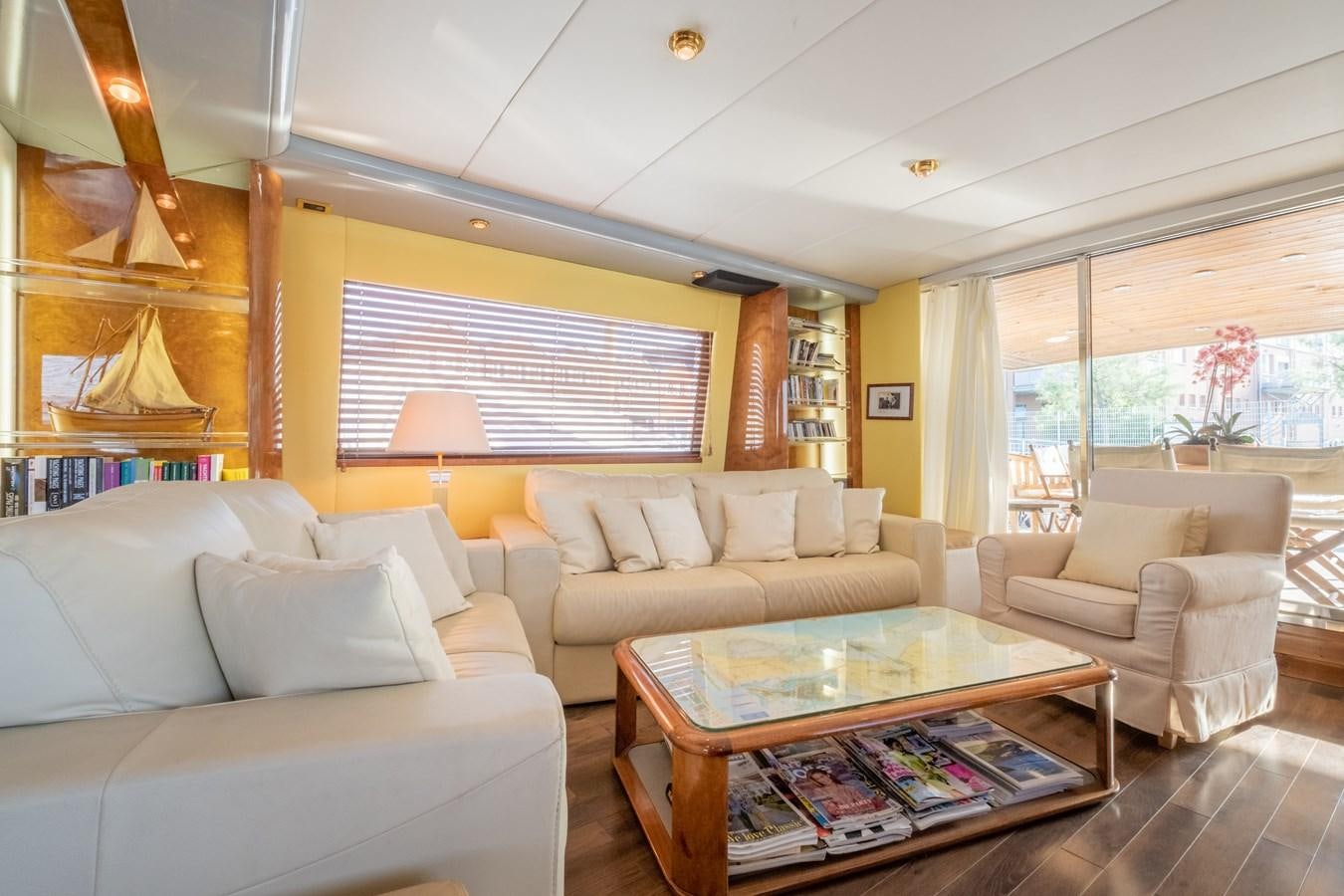 a living room with a table and couches aboard TIENNA Yacht for Sale