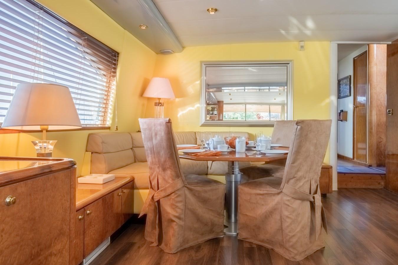 a living room with a couch and a table aboard TIENNA Yacht for Sale