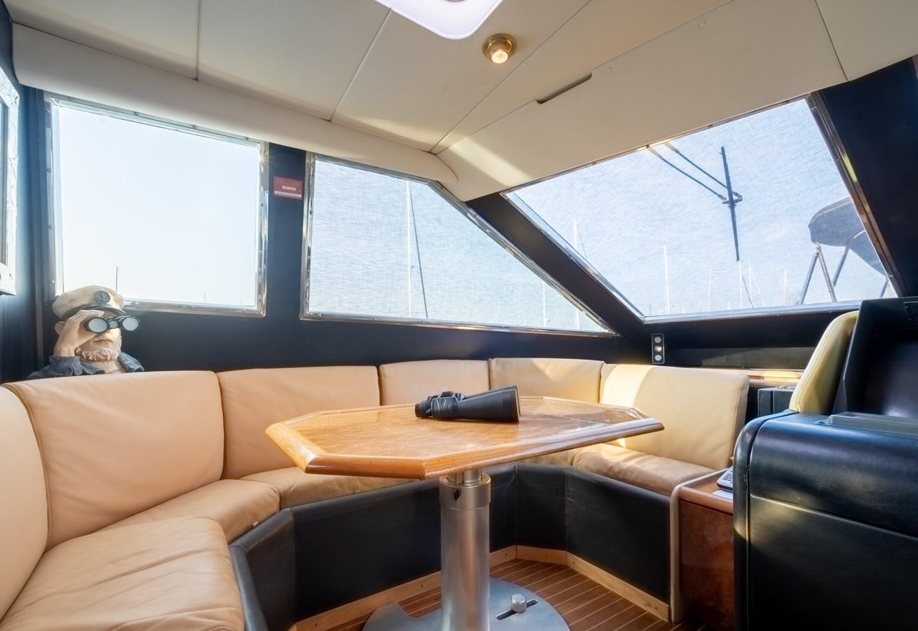 a dog sitting on a couch aboard TIENNA Yacht for Sale