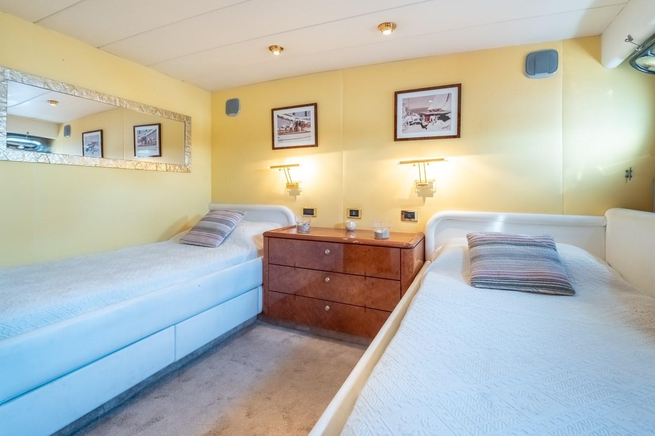 a bedroom with two beds aboard TIENNA Yacht for Sale