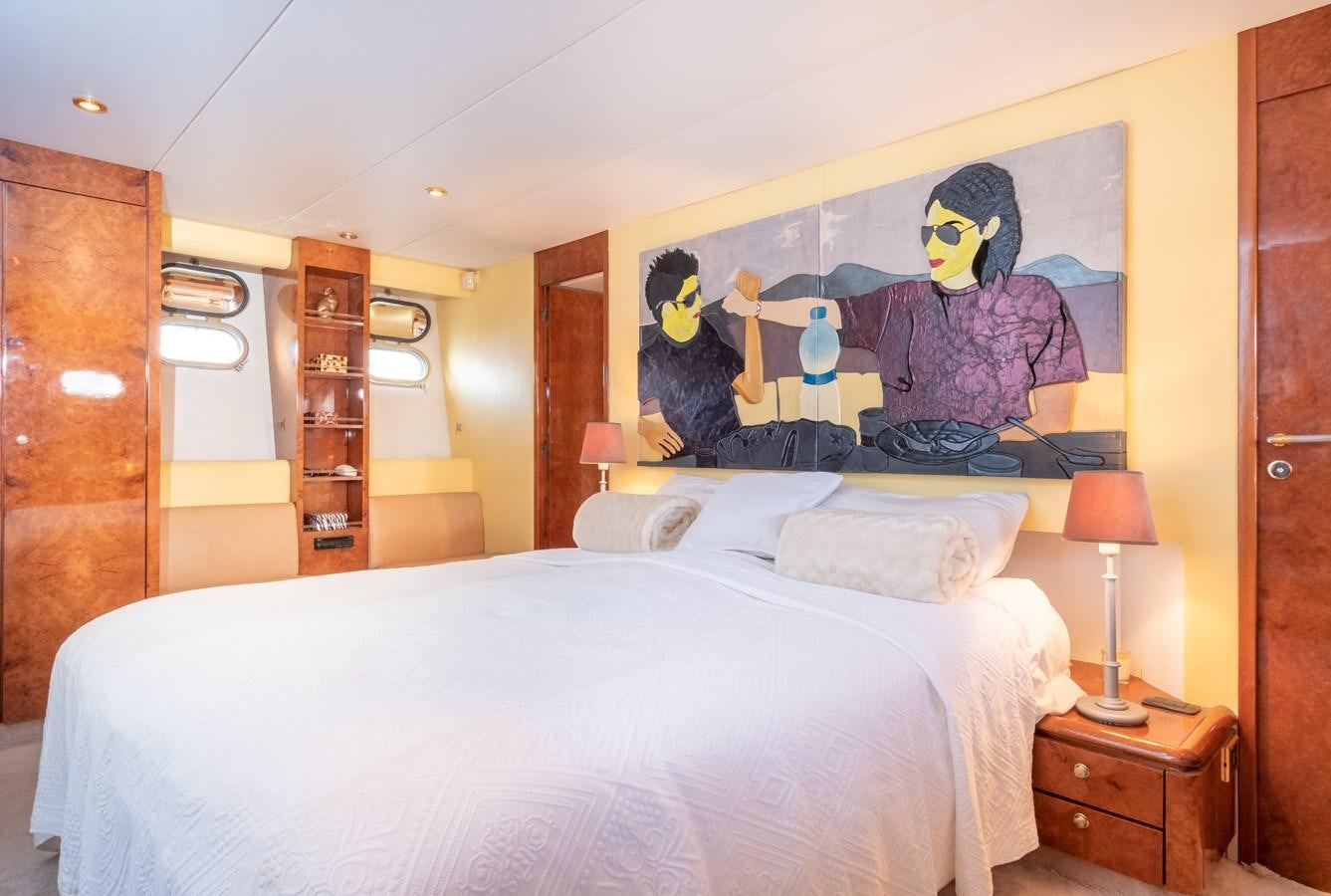 a bedroom with a large painting on the wall aboard TIENNA Yacht for Sale