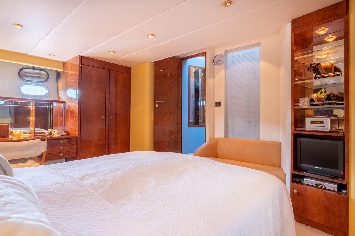a room with a bed and a tv aboard TIENNA Yacht for Sale