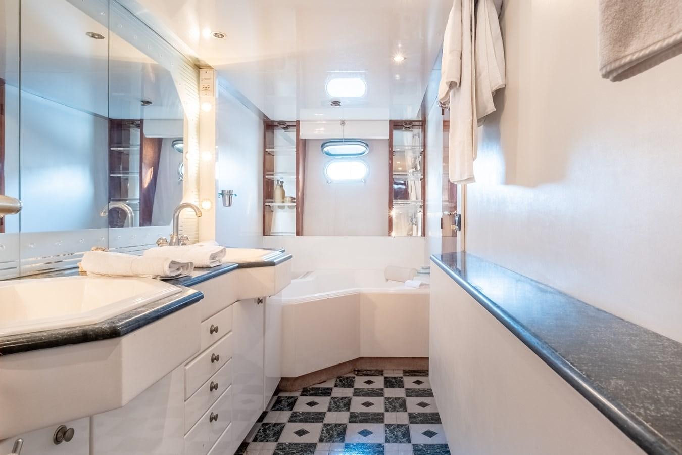 a bathroom with a tub sink and a sink aboard TIENNA Yacht for Sale