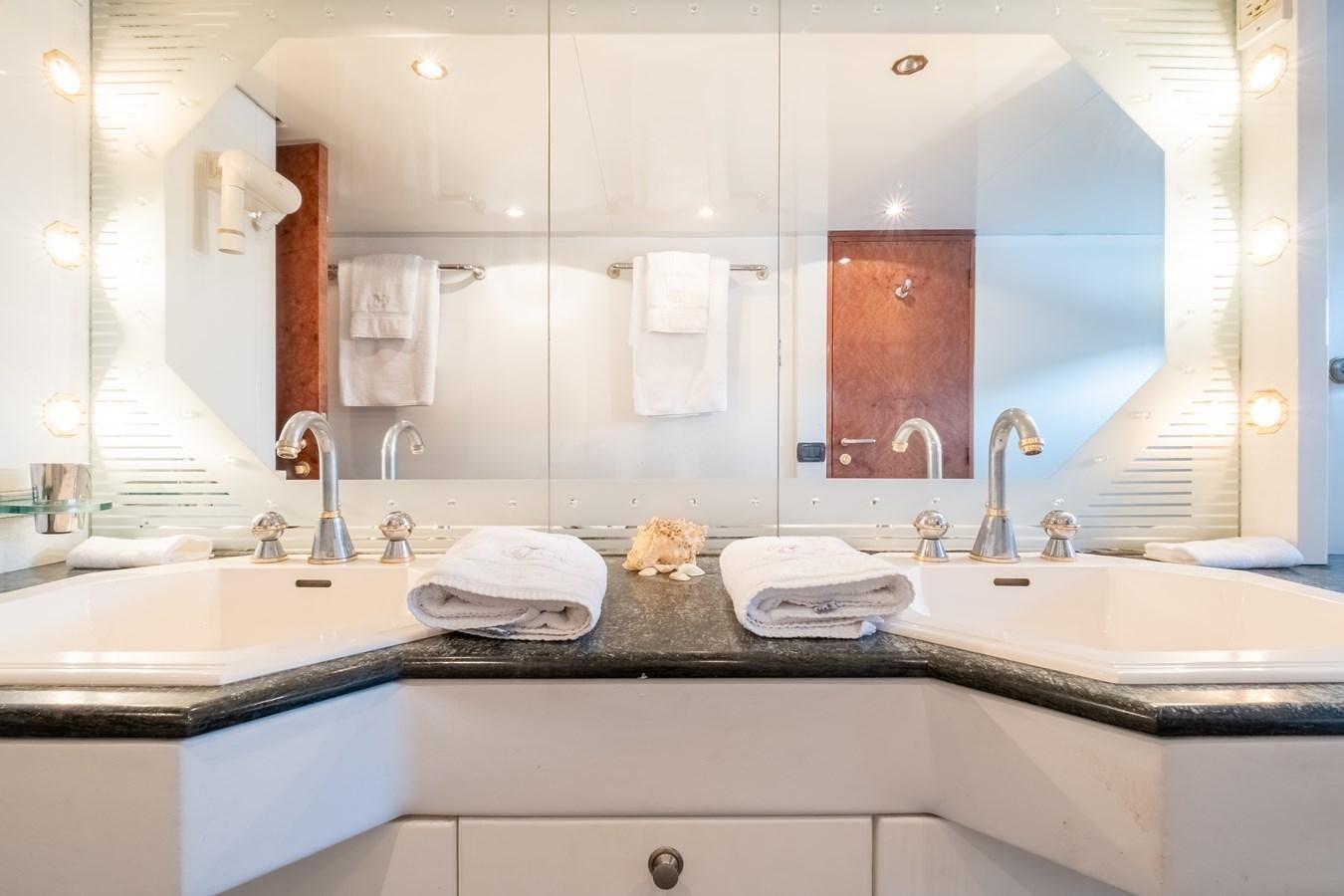 a bathroom with a large mirror aboard TIENNA Yacht for Sale