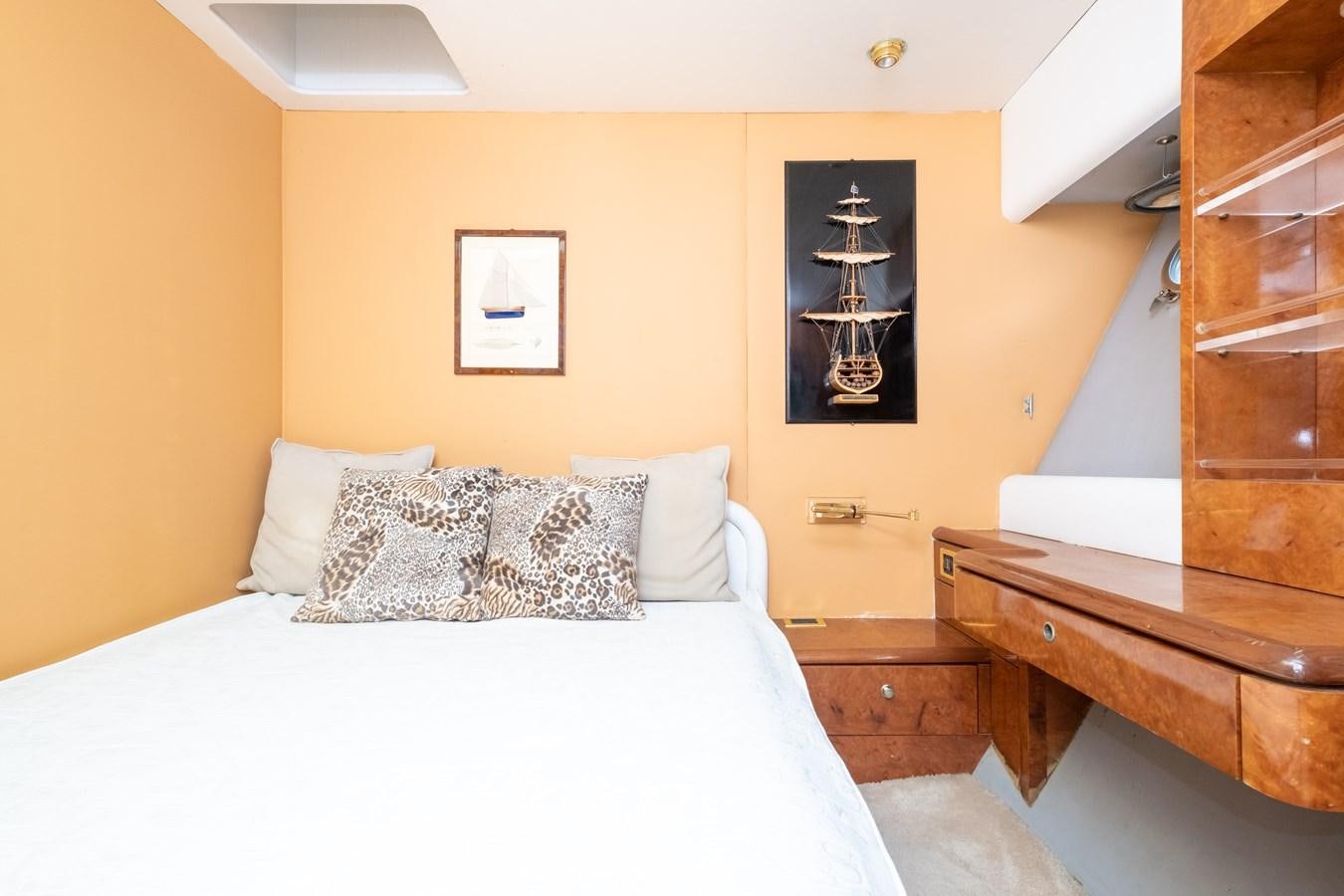 a bedroom with a bed and a desk aboard TIENNA Yacht for Sale