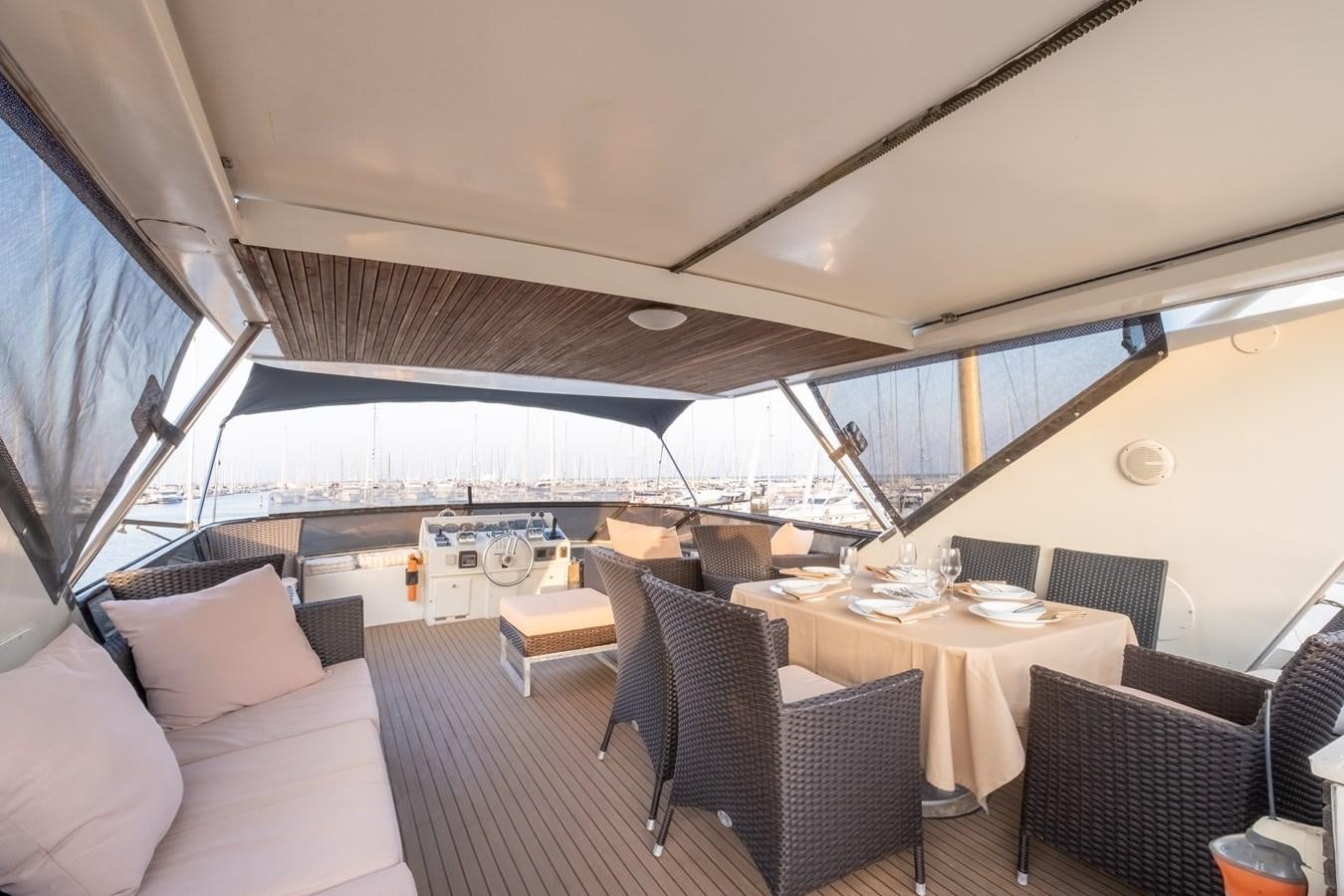 a large room with a table and chairs aboard TIENNA Yacht for Sale