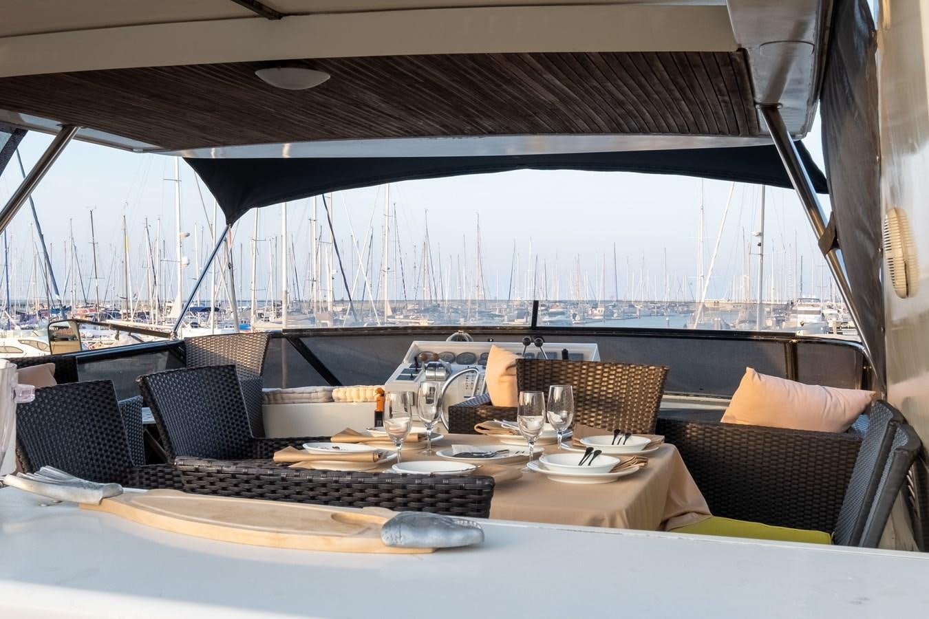 a table with chairs and a computer aboard TIENNA Yacht for Sale