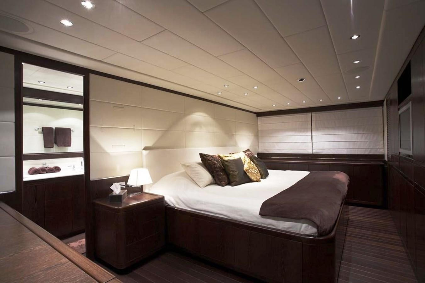 a room with a bed and a desk aboard L'ESPERANCE Yacht for Sale
