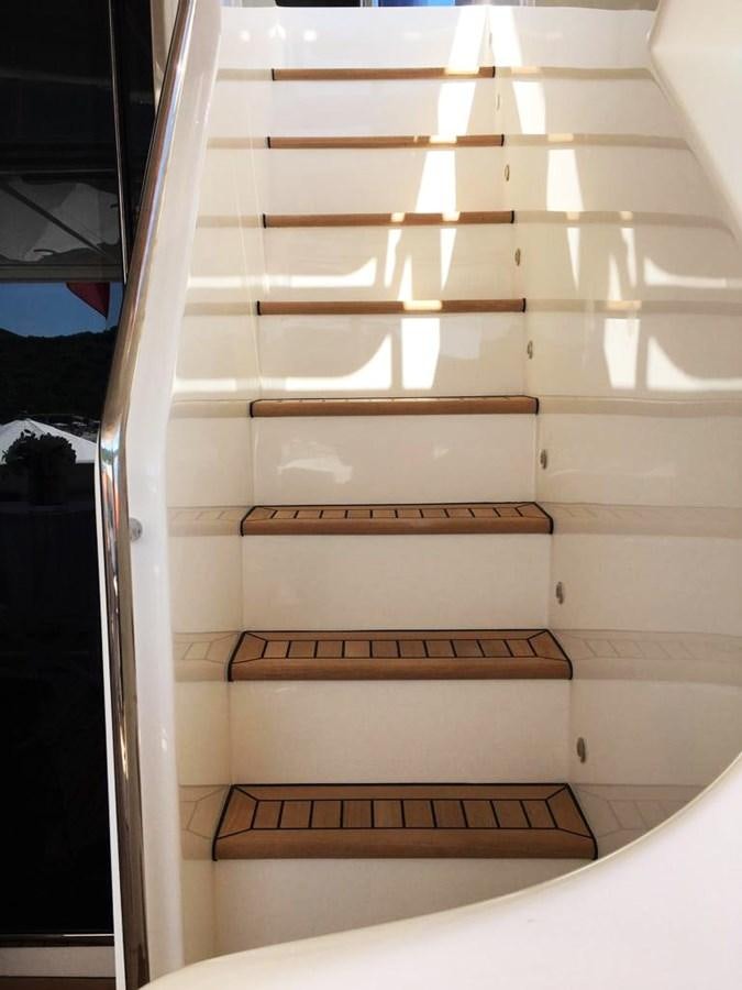 a white staircase with a wooden railing aboard PALGREMAT Yacht for Sale
