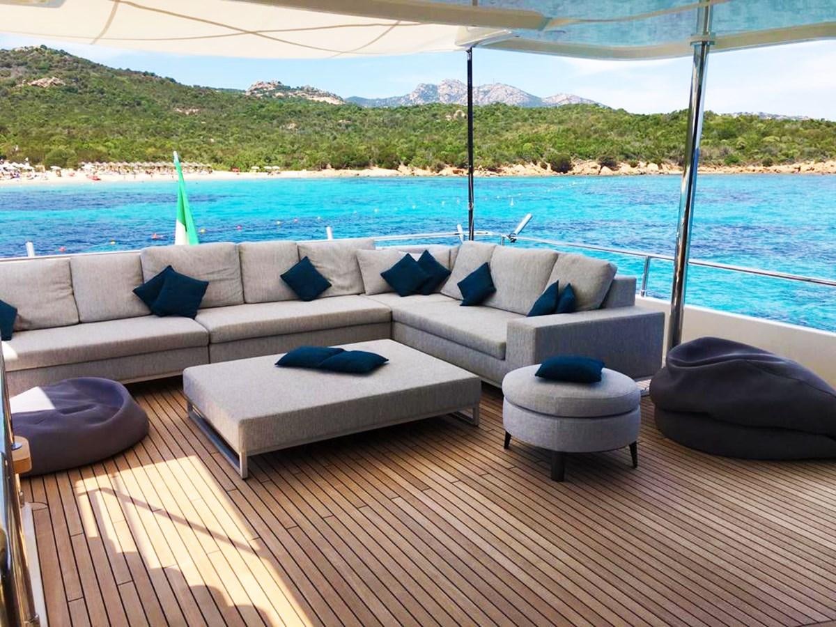 a couch on a deck overlooking a body of water aboard PALGREMAT Yacht for Sale