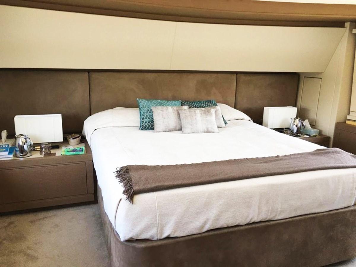 a bed with a white comforter aboard PALGREMAT Yacht for Sale