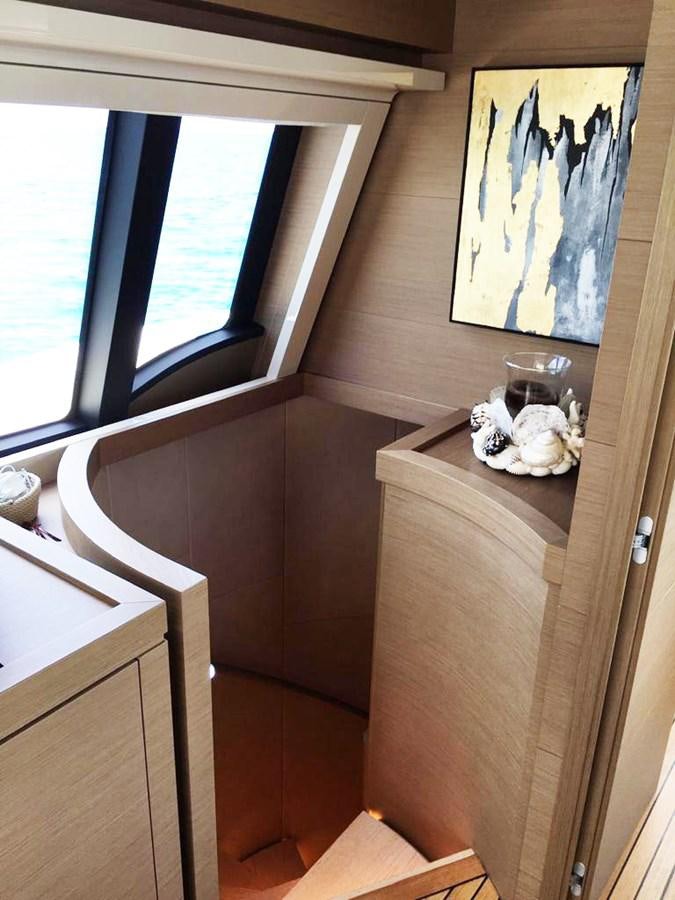a wooden shelf with a glass of wine on it aboard PALGREMAT Yacht for Sale