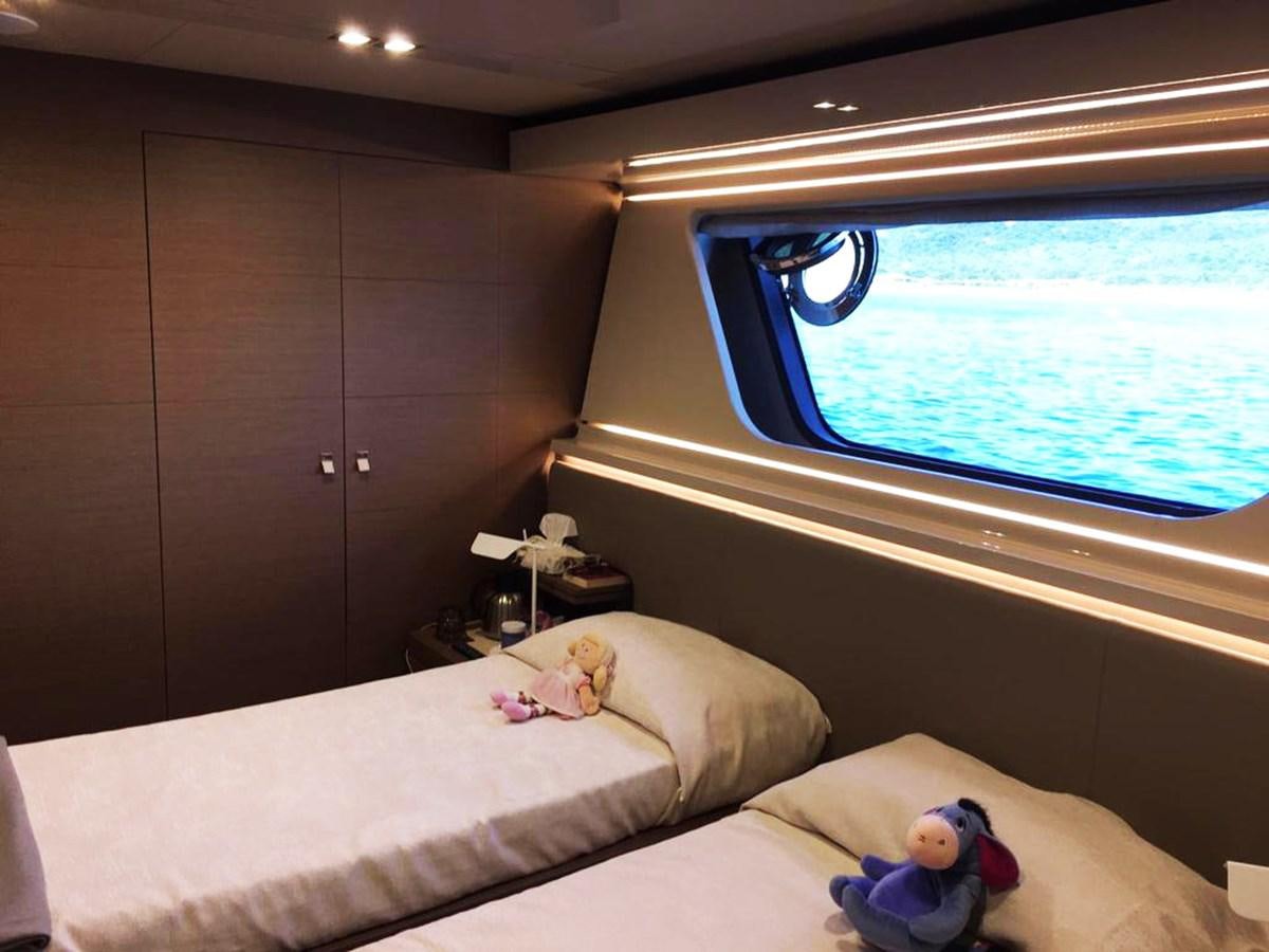a bedroom with a window and a bed aboard PALGREMAT Yacht for Sale