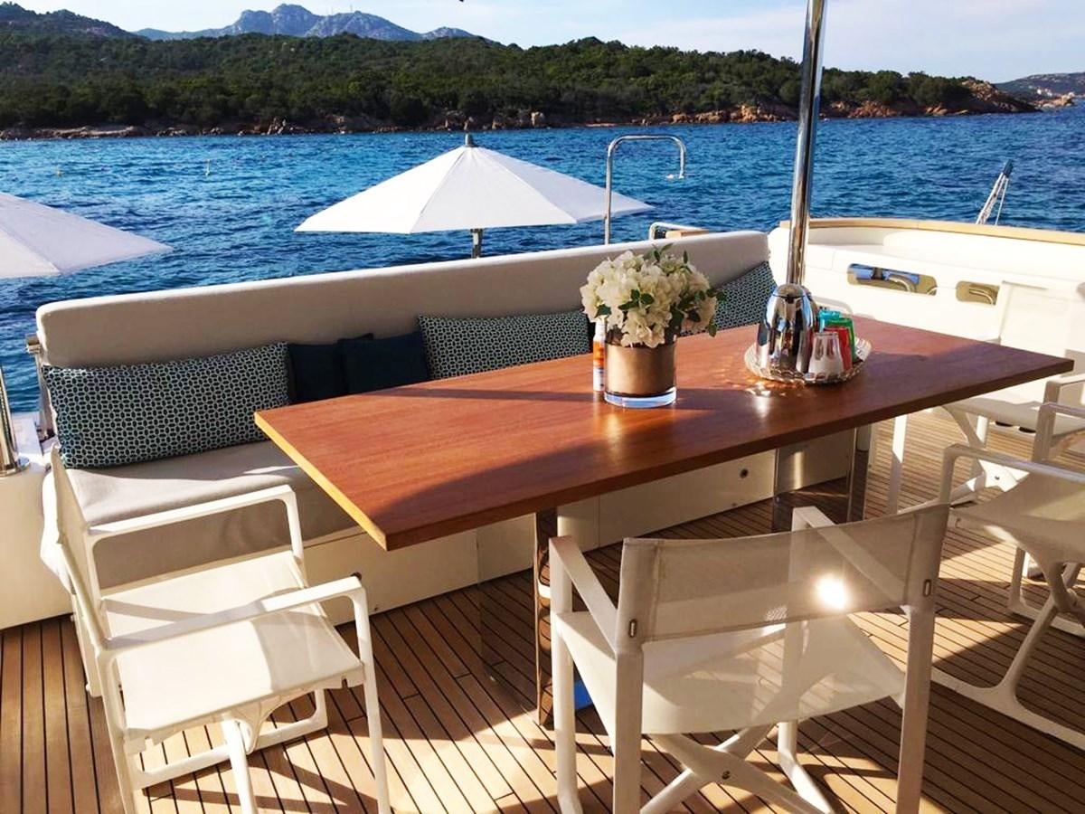 a table with chairs on it next to a body of water aboard PALGREMAT Yacht for Sale