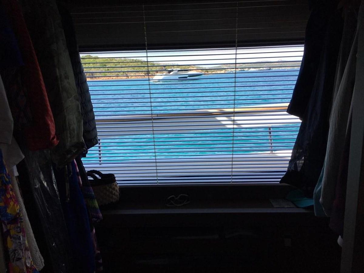 a window with blue blinds aboard PALGREMAT Yacht for Sale