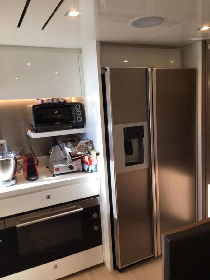 a kitchen with a refrigerator and a microwave aboard PALGREMAT Yacht for Sale