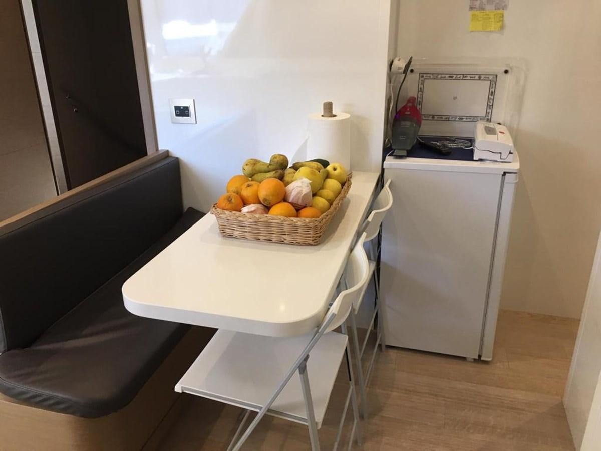 a table with a basket of fruit on it aboard PALGREMAT Yacht for Sale