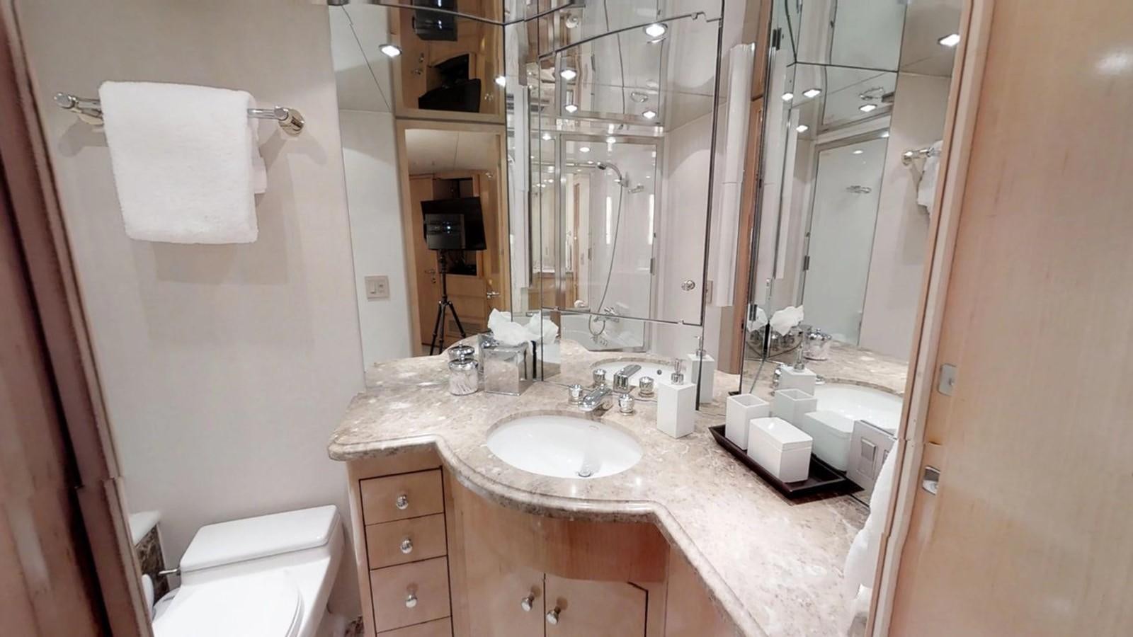 a bathroom with a sink and a mirror aboard 92' HATTERAS Yacht for Sale