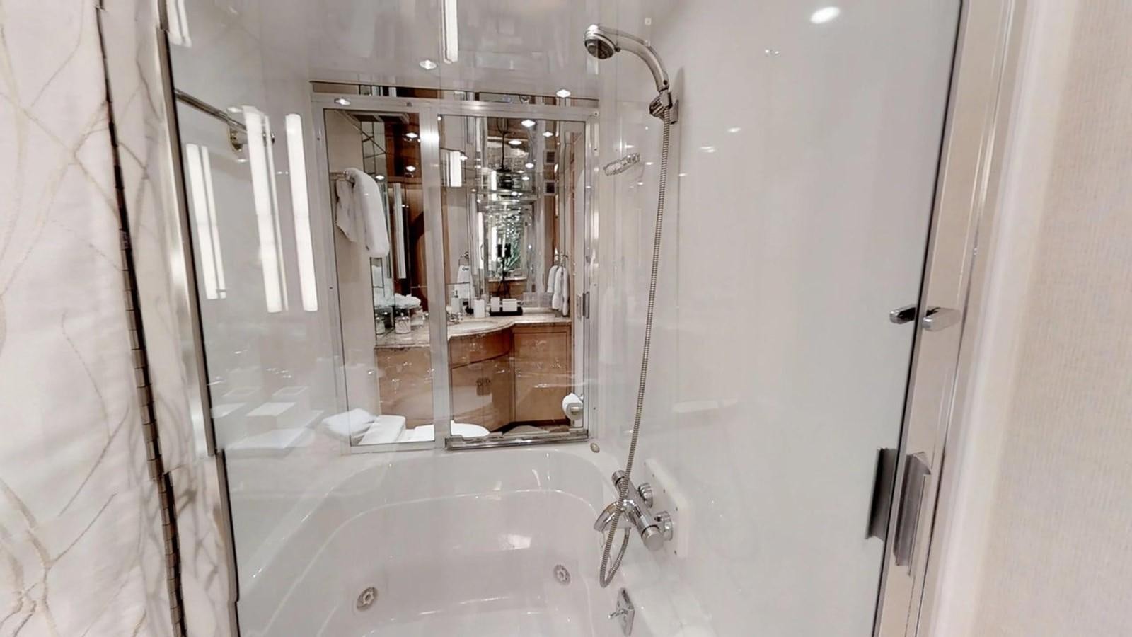 a bathroom with a large mirror aboard 92' HATTERAS Yacht for Sale