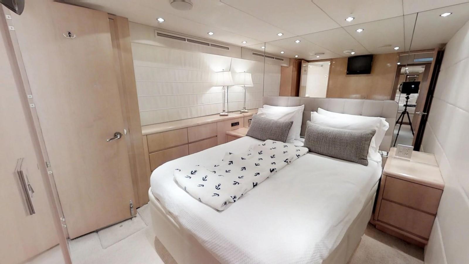 a room with a bed and a lamp aboard 92' HATTERAS Yacht for Sale