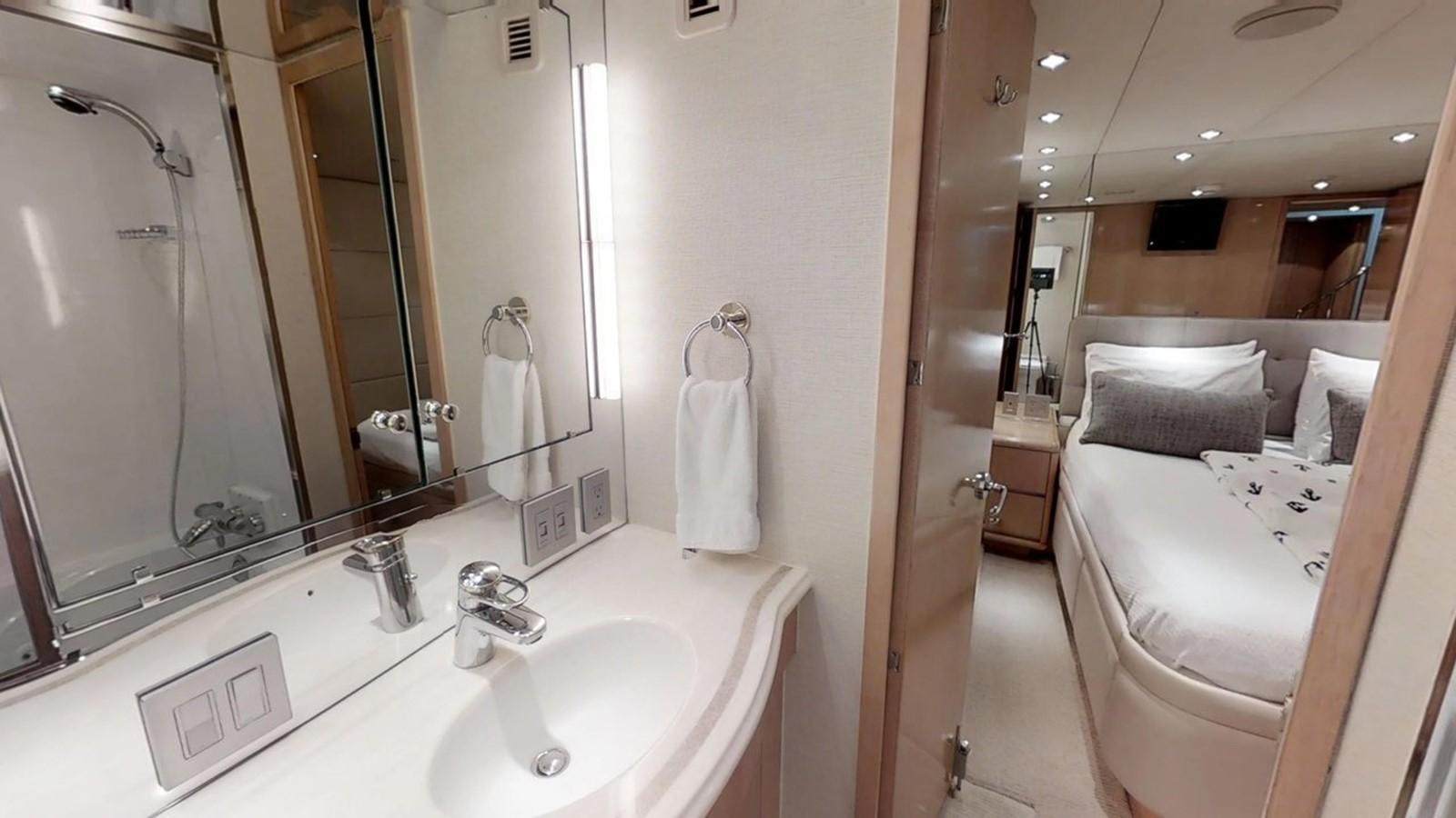a bathroom with a large mirror aboard 92' HATTERAS Yacht for Sale