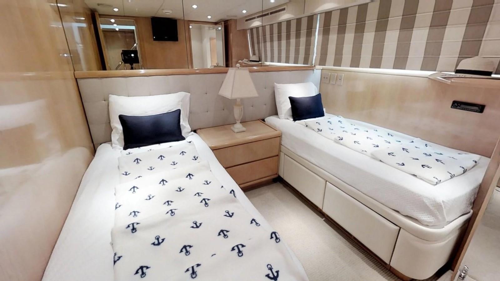 a room with two beds aboard 92' HATTERAS Yacht for Sale