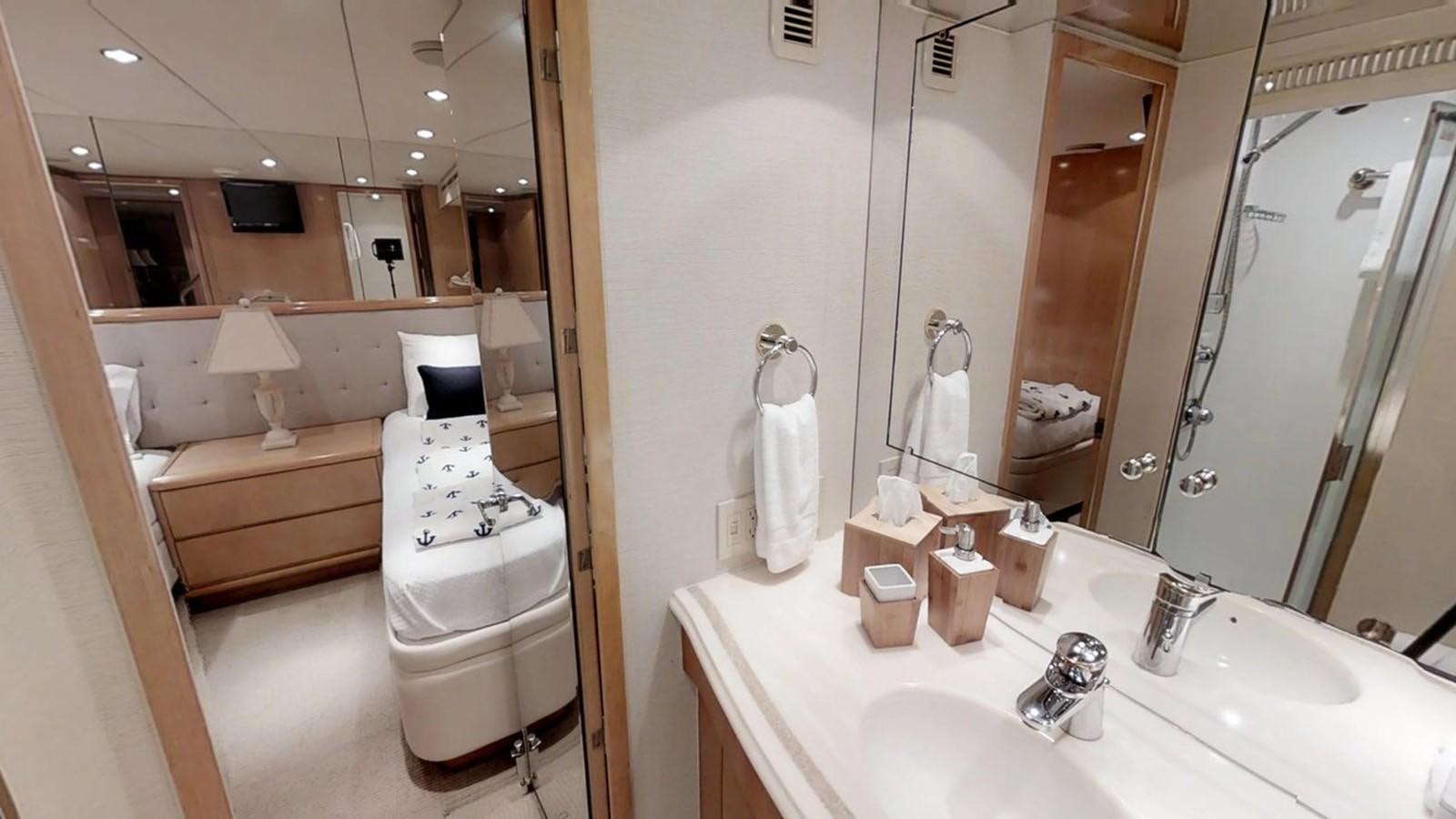 a bathroom with a large mirror aboard 92' HATTERAS Yacht for Sale