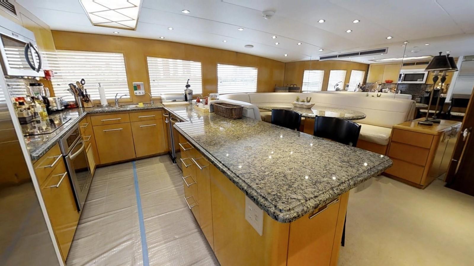 a large kitchen with marble counters aboard 92' HATTERAS Yacht for Sale