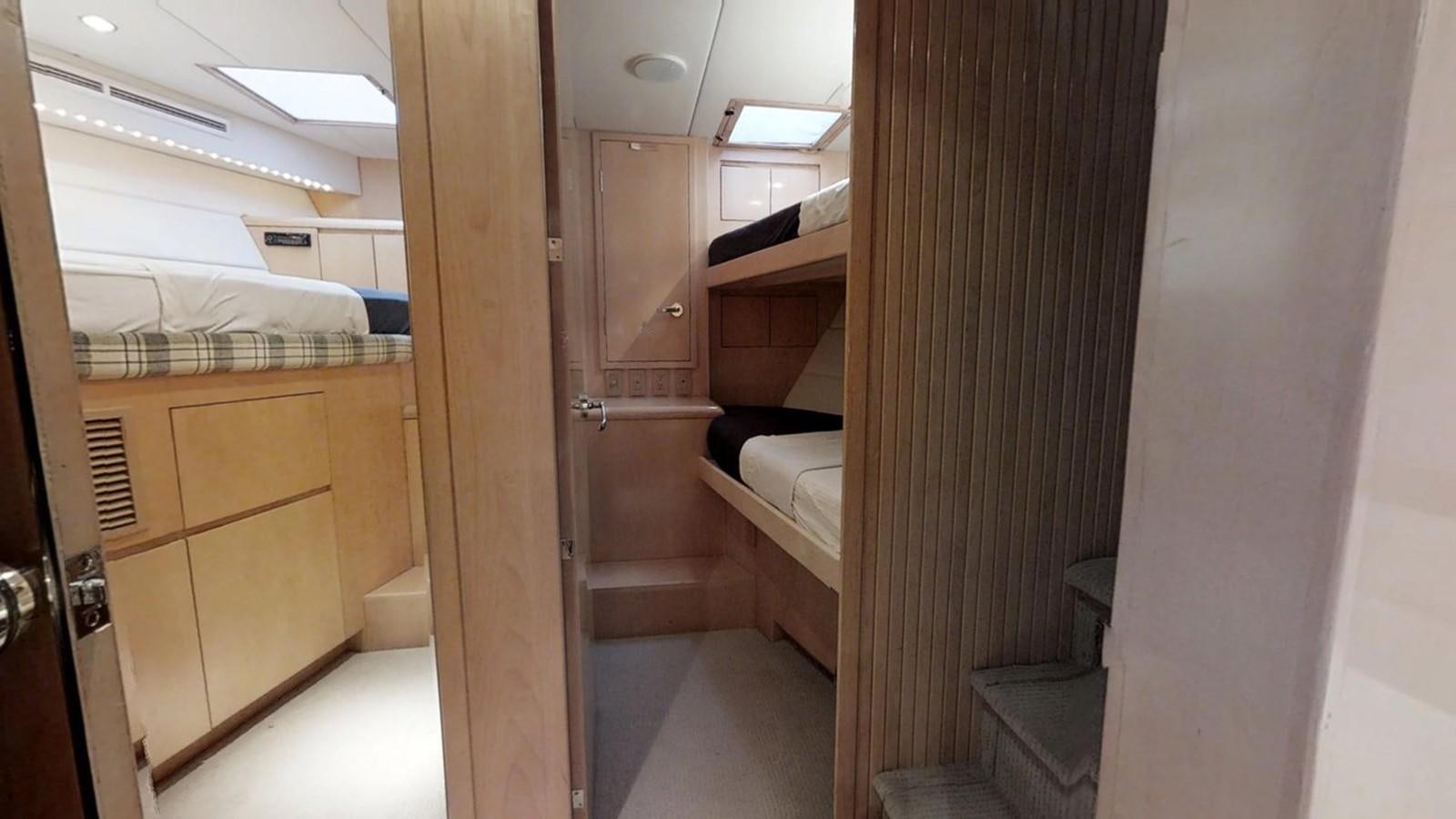 a room with a bed and a closet aboard 92' HATTERAS Yacht for Sale