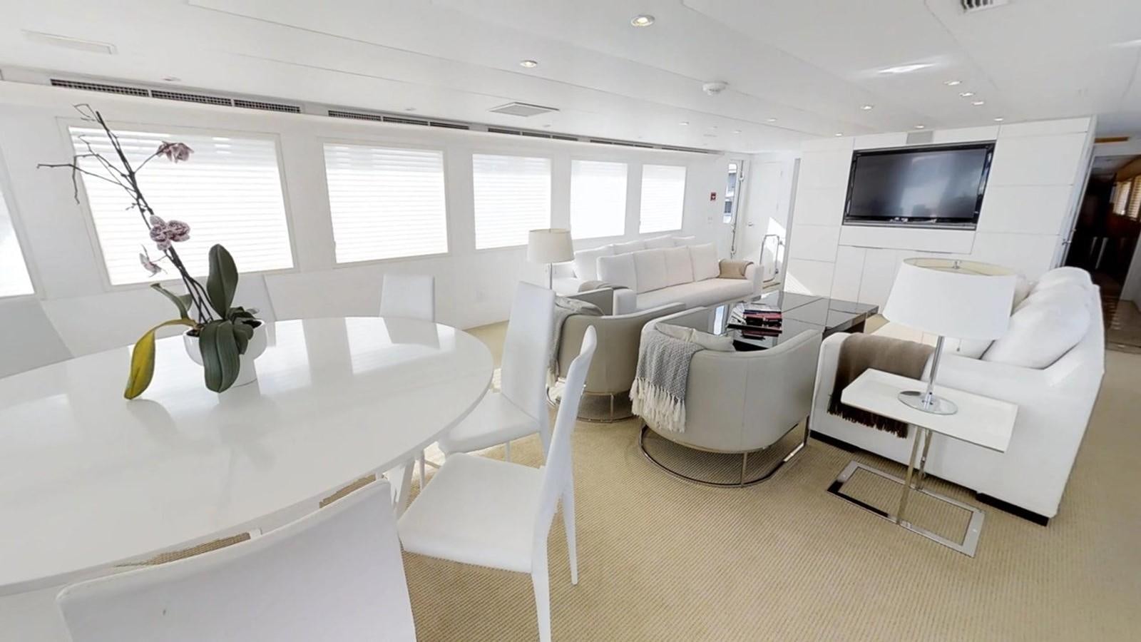 a living room with white furniture aboard 92' HATTERAS Yacht for Sale