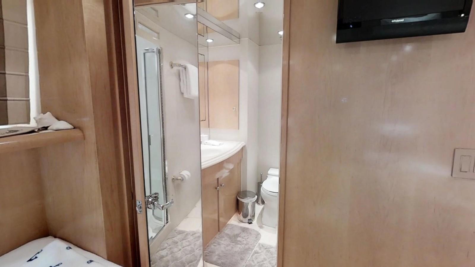 a bathroom with a sink and a toilet aboard 92' HATTERAS Yacht for Sale