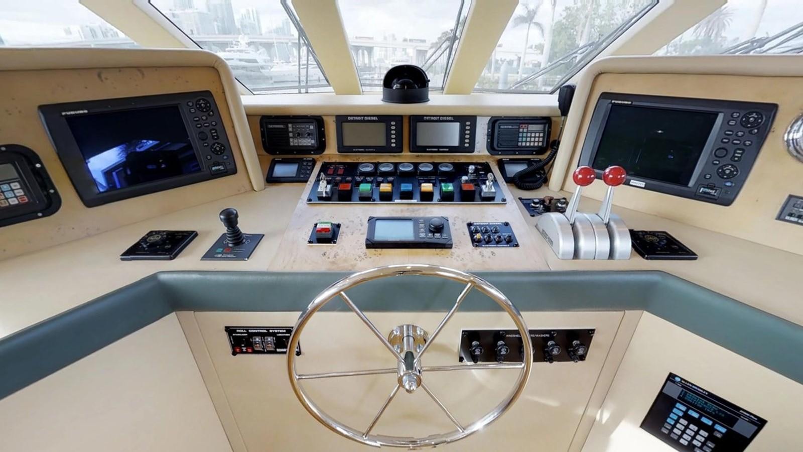 a group of electronic devices on a table aboard 92' HATTERAS Yacht for Sale
