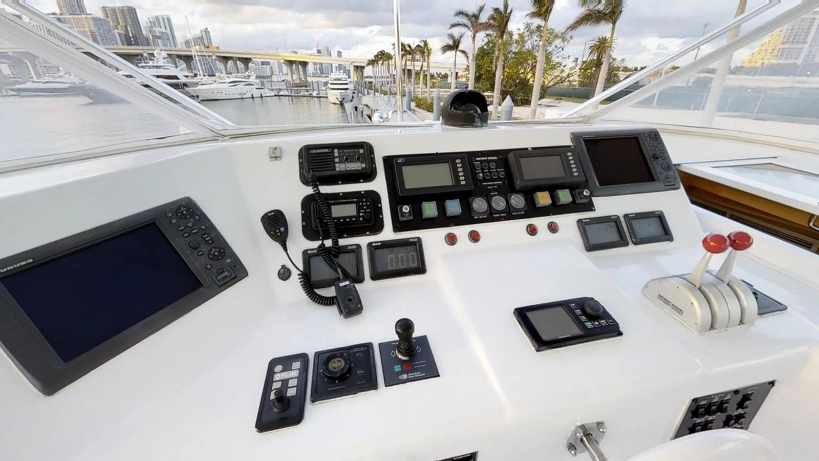 a group of electronics on a table aboard 92' HATTERAS Yacht for Sale