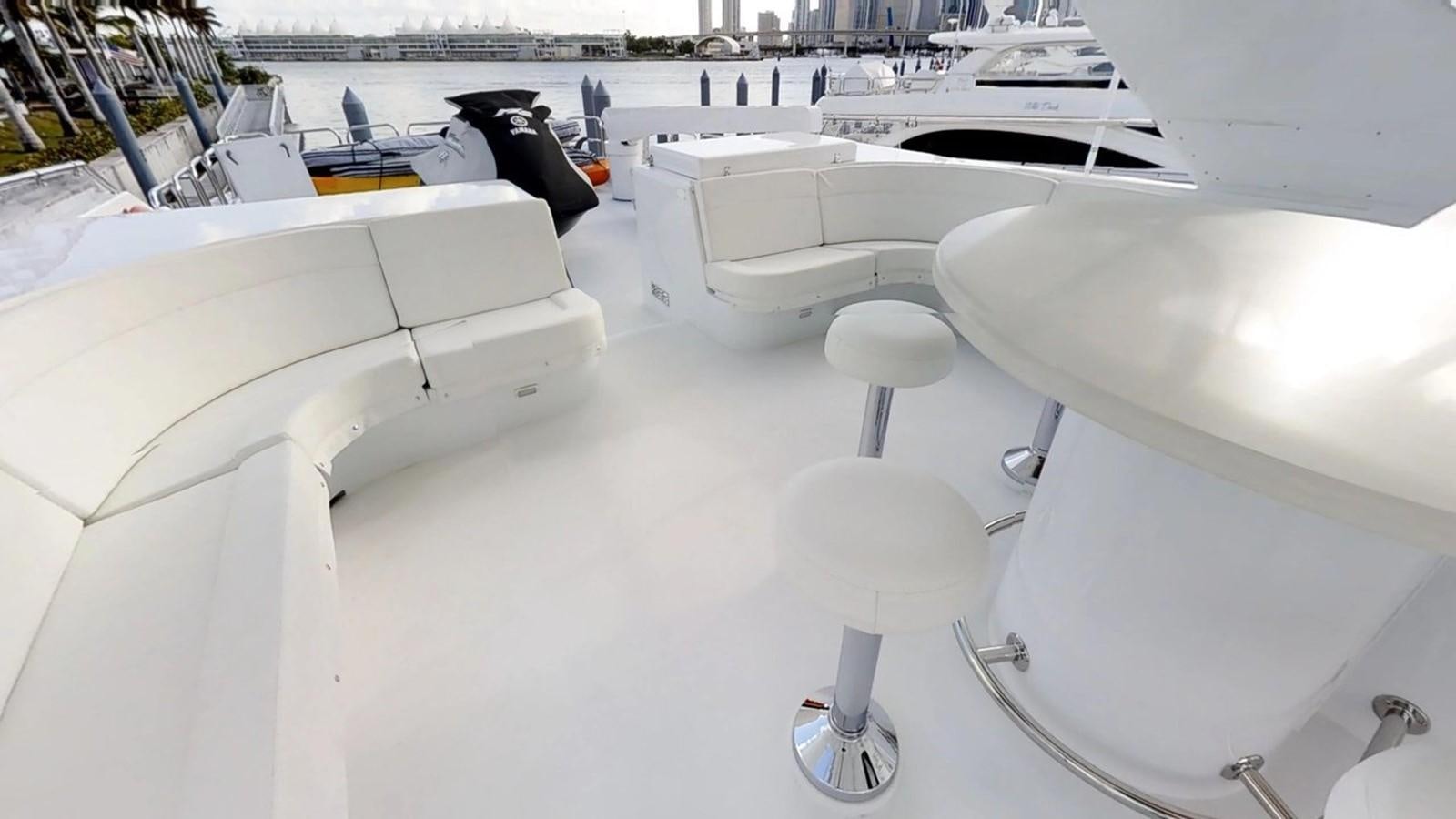 a room with white furniture aboard 92' HATTERAS Yacht for Sale