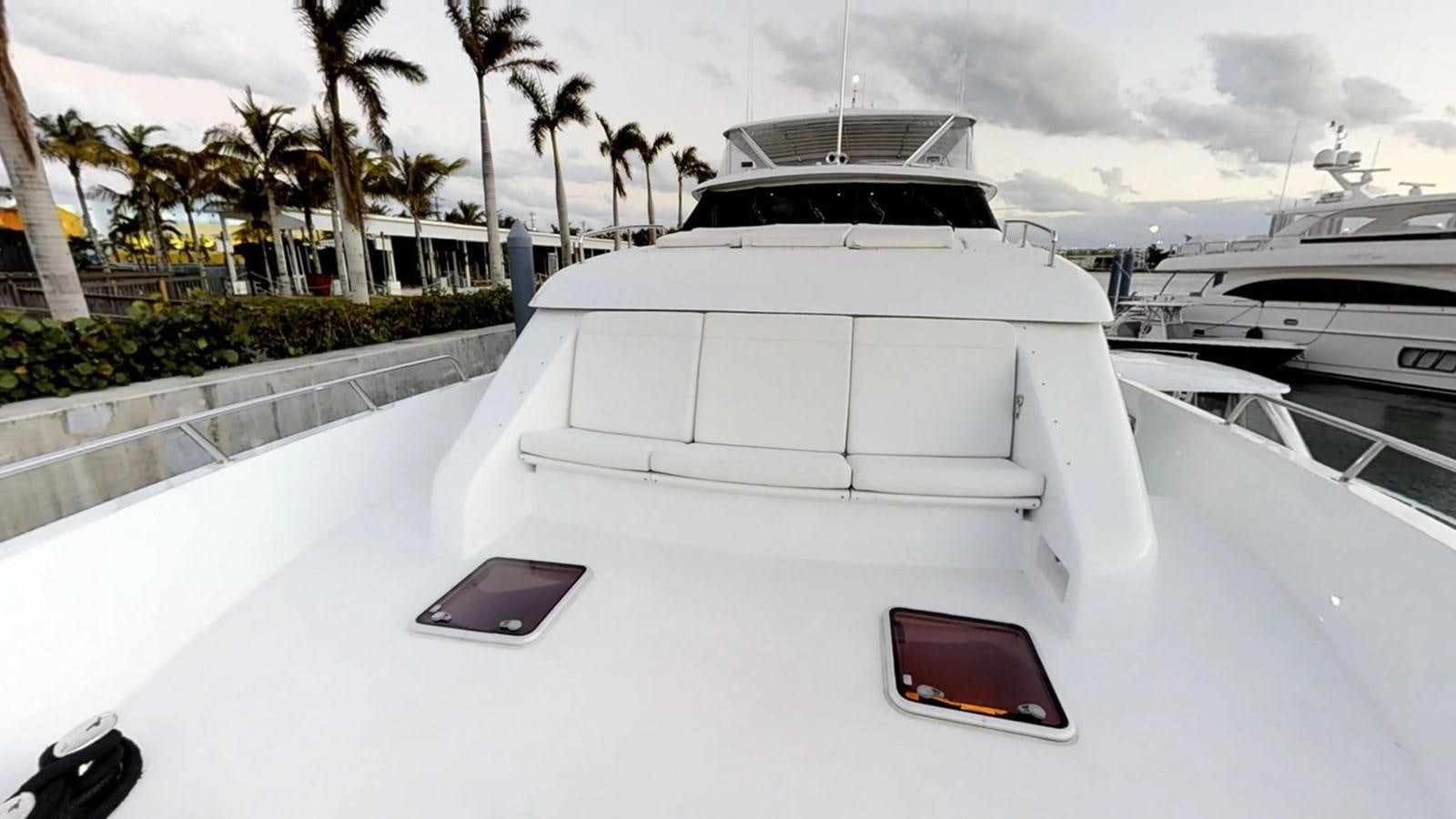 a white car parked on a white car with a black background aboard 92' HATTERAS Yacht for Sale